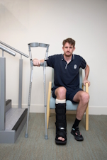 photo showing someone sitting with the crutches in a H shape ready to stand up as described in the text