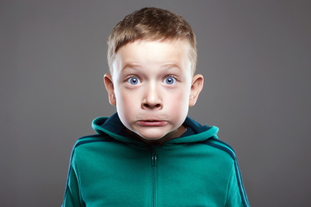 A boy grimaces during a tic