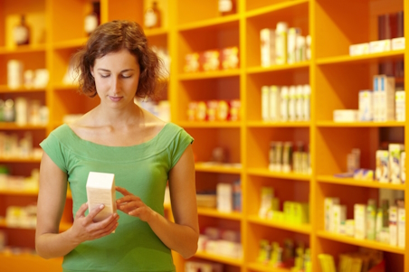 Young woman reading a medicine label